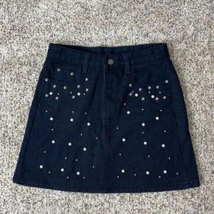 Black denim skirt with metal and pearl buttons. Size SMALL.
